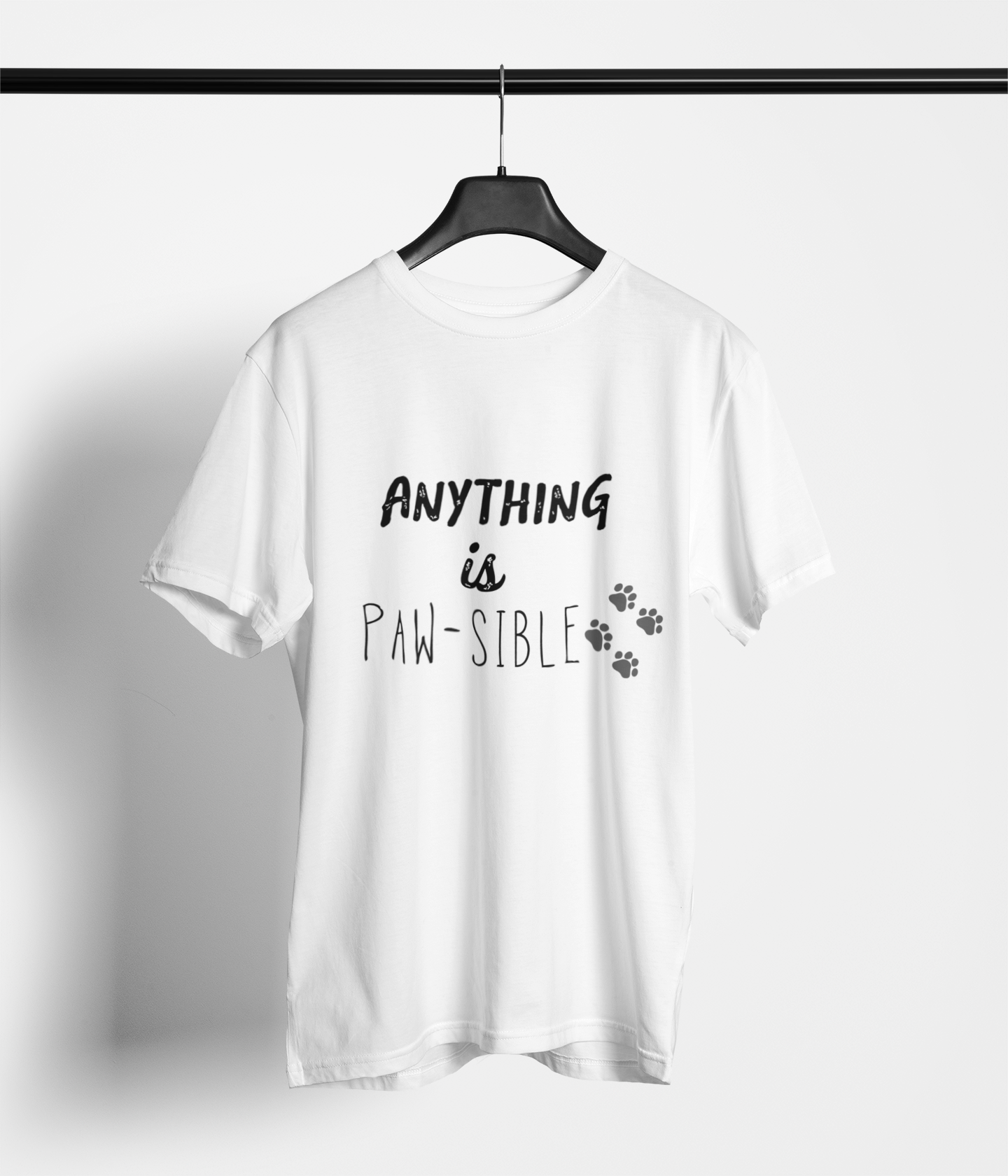 White t-shirt with “Anything is Paw‑sible” text and paw prints